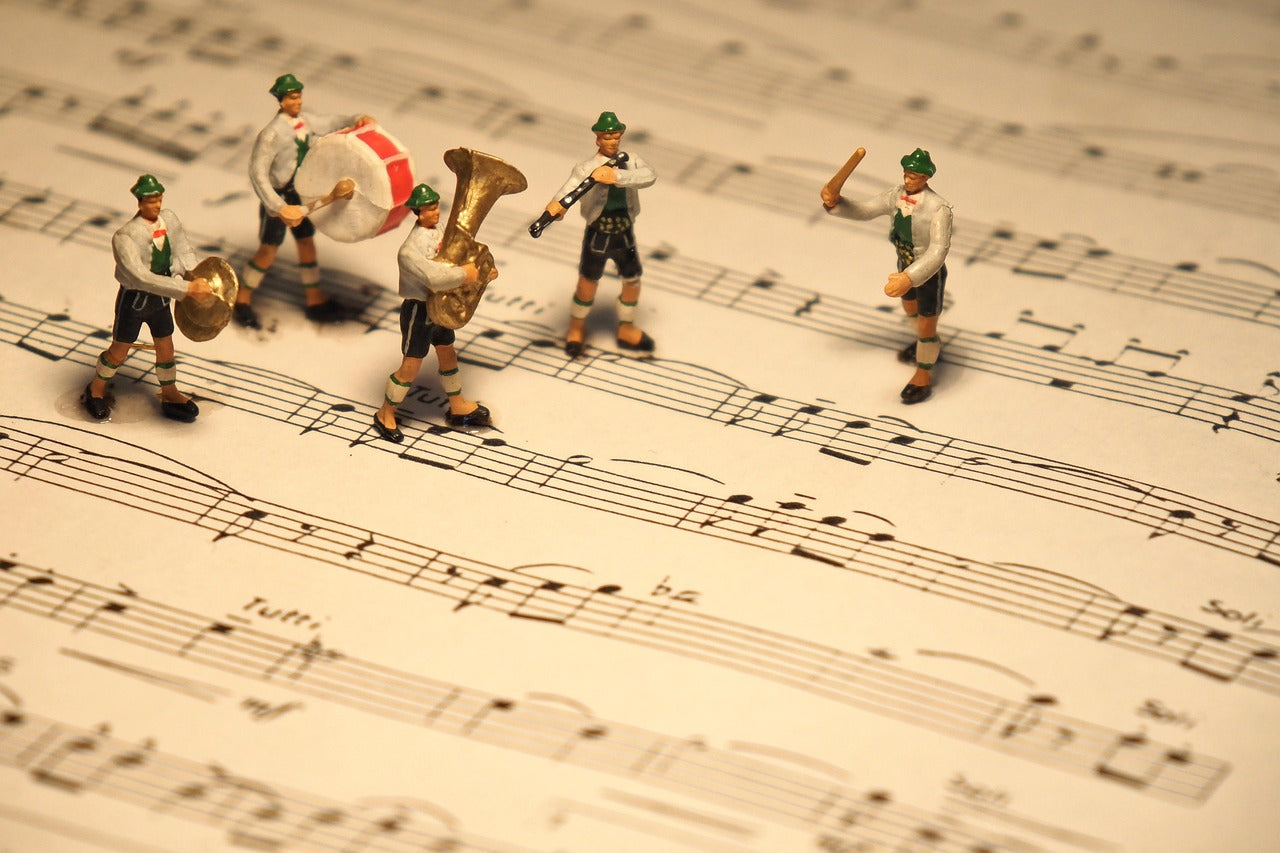 Band standing on top of sheet music