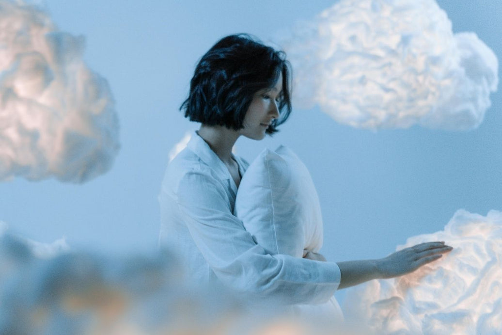 Woman touching clouds while lucid dreaming