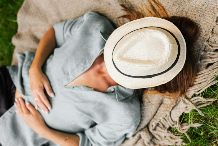woman napping outside on a blanket