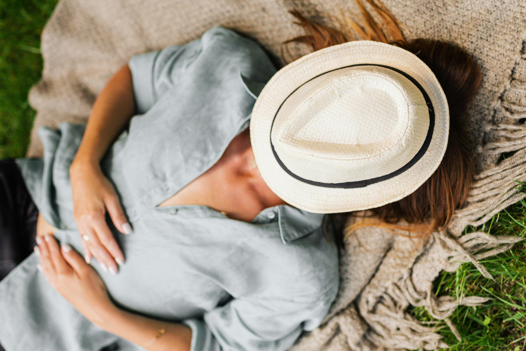 woman napping outside on a blanket