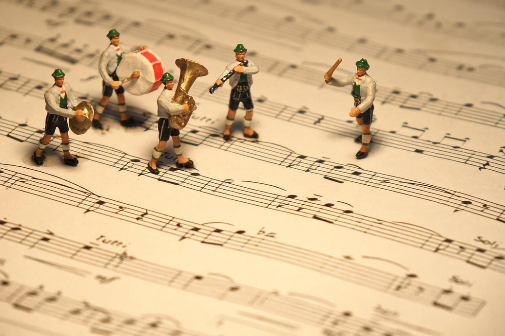 Band standing on top of sheet music