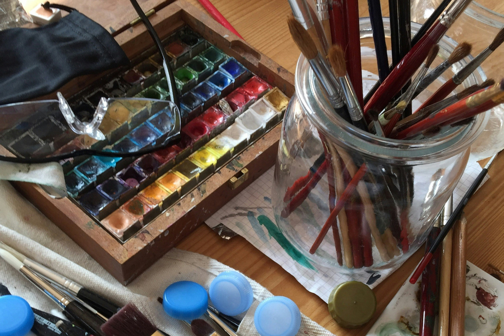 Paint brushes, paint, and safety glasses set out after a good night's sleep